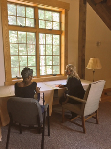 Carmen Oliver (right) working with an author at our Retreat Center.