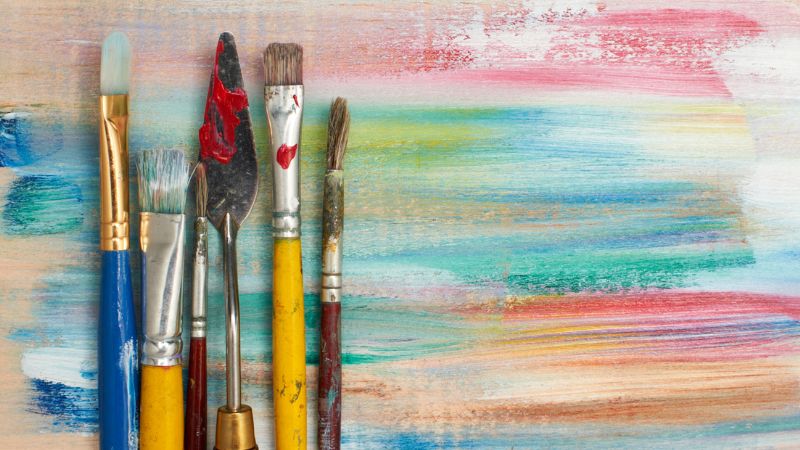 paintbrushes on a color background