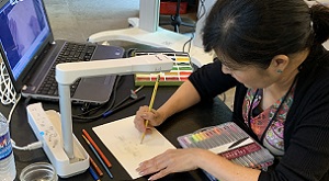Photo of children's book illustrator at work