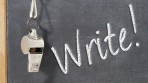 Coach's whistle hanging on chalkboard with the word "write" on it