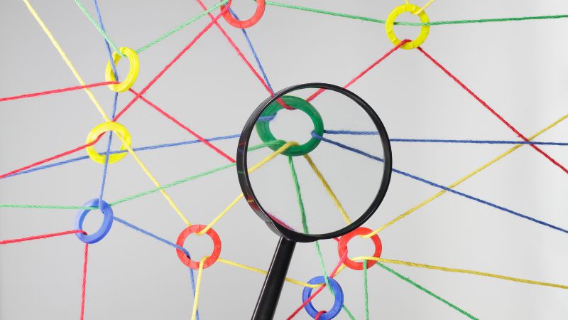A web of connections with a magnifying glass (Relationships featured image)