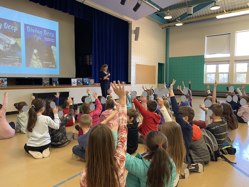 Michelle Cusolito interacting at a school visit.