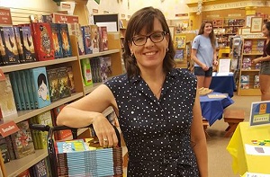Author Jennifer Swanson with stacks of her books