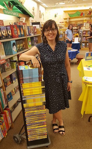Author Jennifer Swanson with a stack of her books