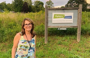 Photo of Doreen Klein Robinson and the Highlights Foundation sign