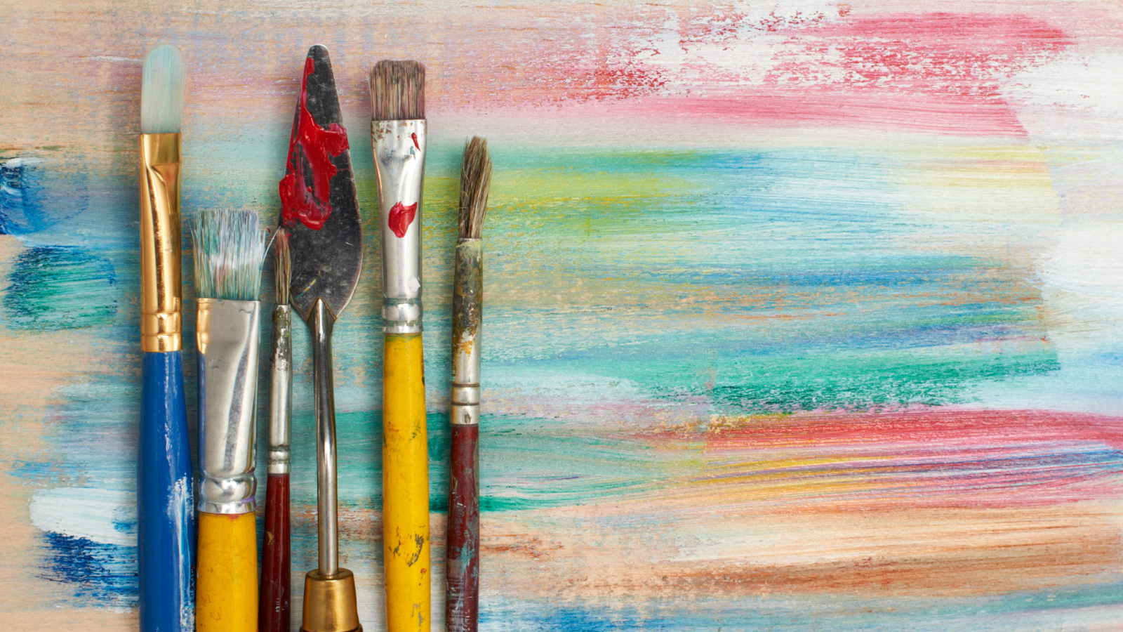 paintbrushes on colorful background