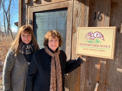 Heidi EY Stemple and Jane Yolen in front of the Jane Yolen Cabin