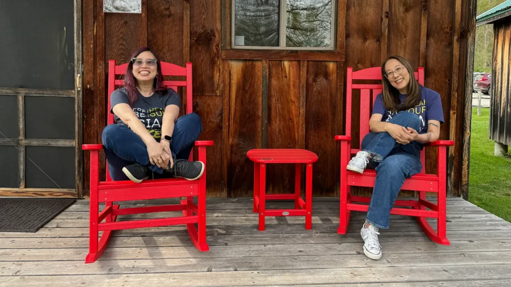 retreat hosts grace lin and debbi michiko florence in front of cabin 8