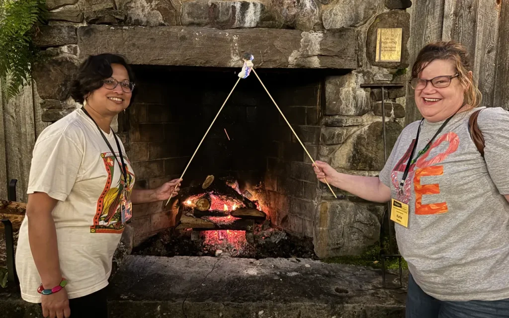 guests in front of the fireplace roasting marshmellows
