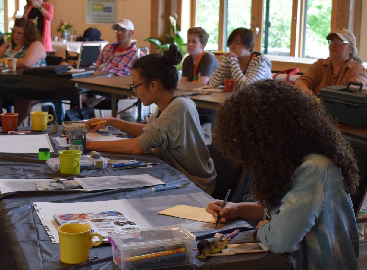 Photo of Summer Camp attendees working on illustrations