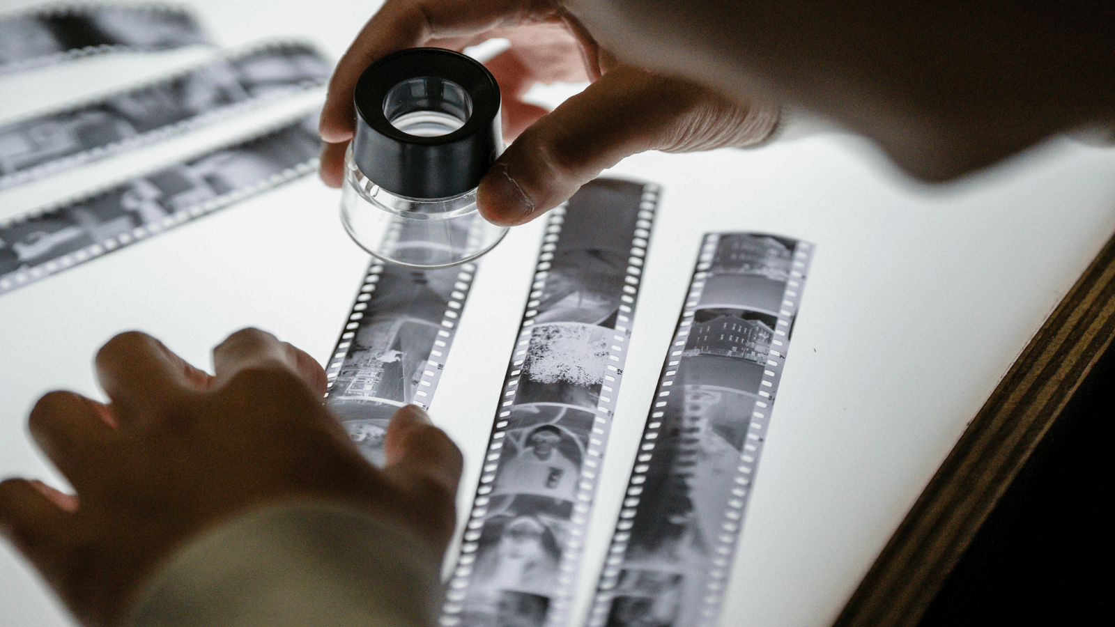 a photographers contact sheet, with a magnifying glass